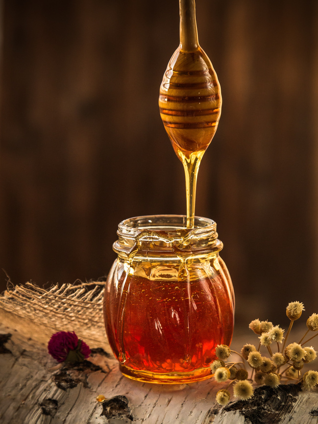 Jar of Honey on Wooden Background